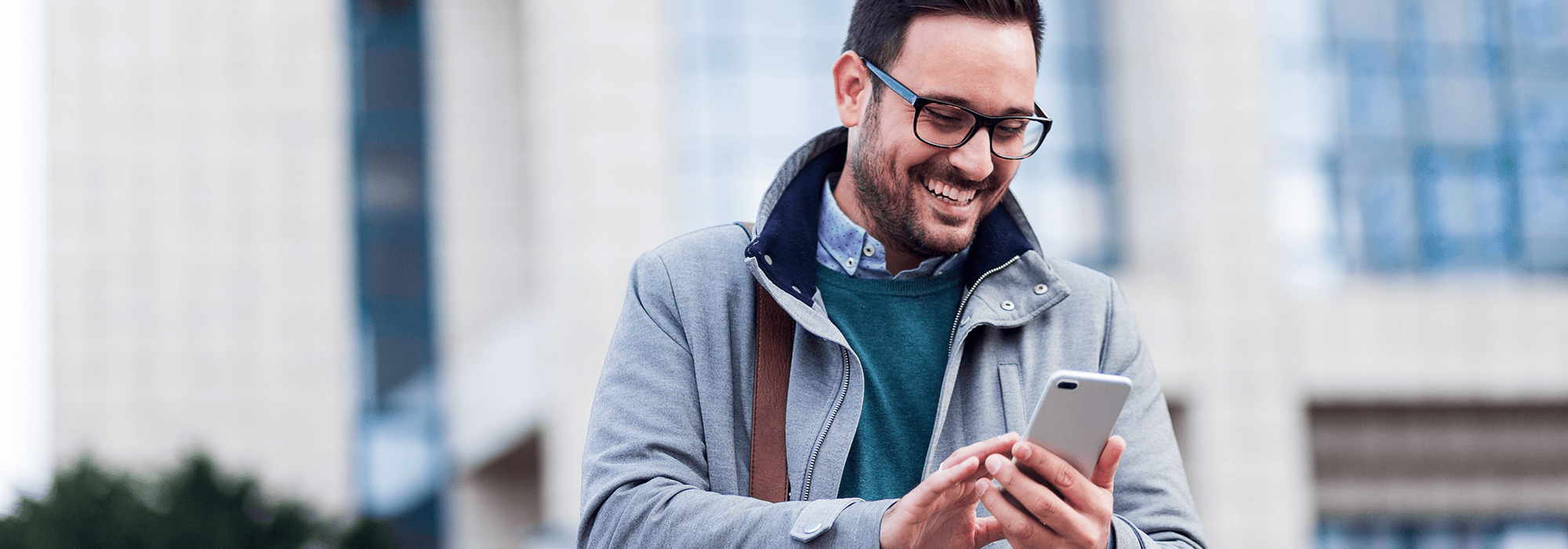 man smiling at his phone