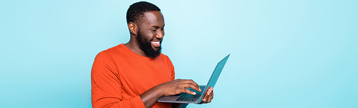 African American man on his laptop sets up internet security safeguards